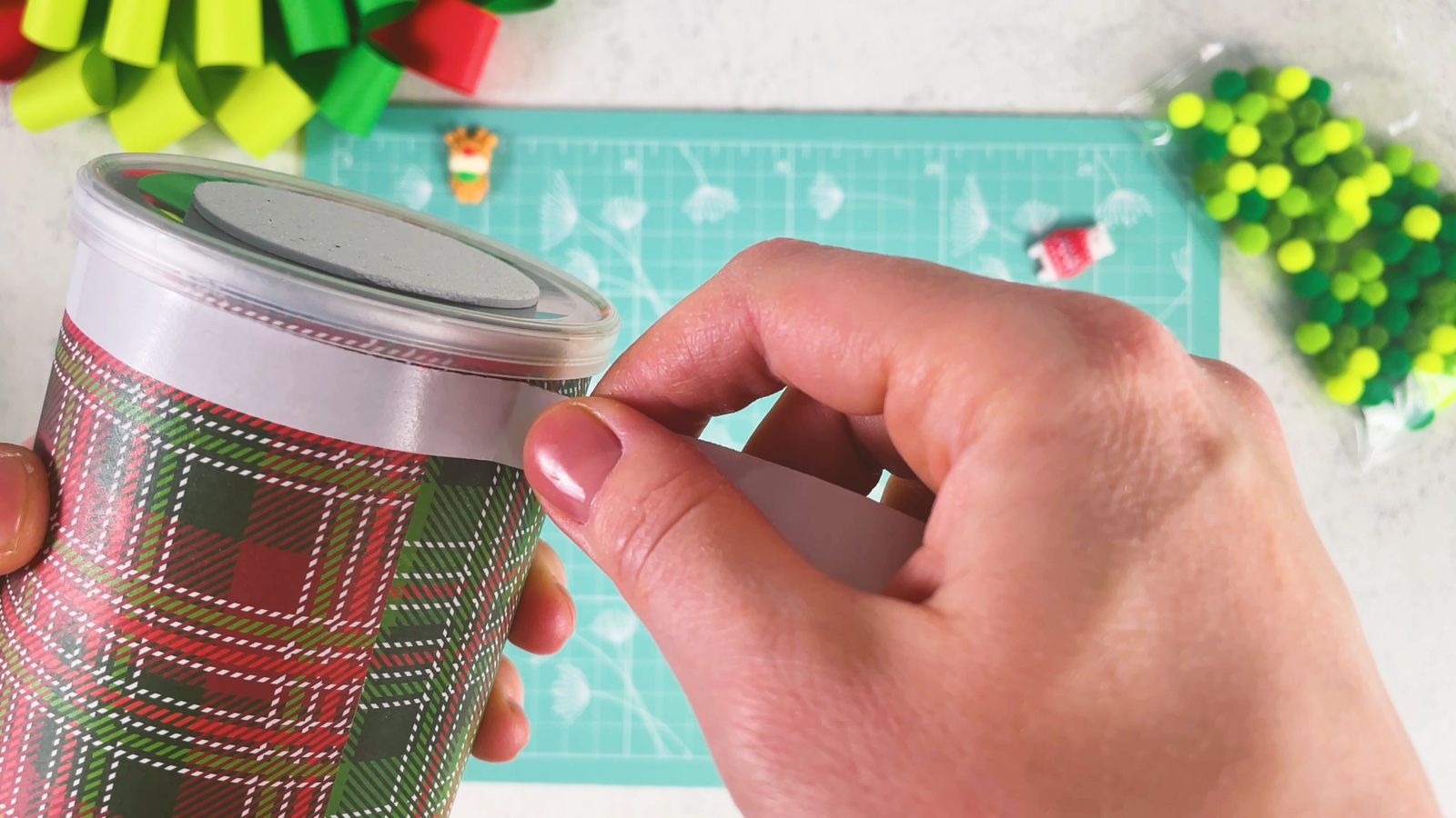 Wrapping white double-sided tape around the top edge of the can, under the lid