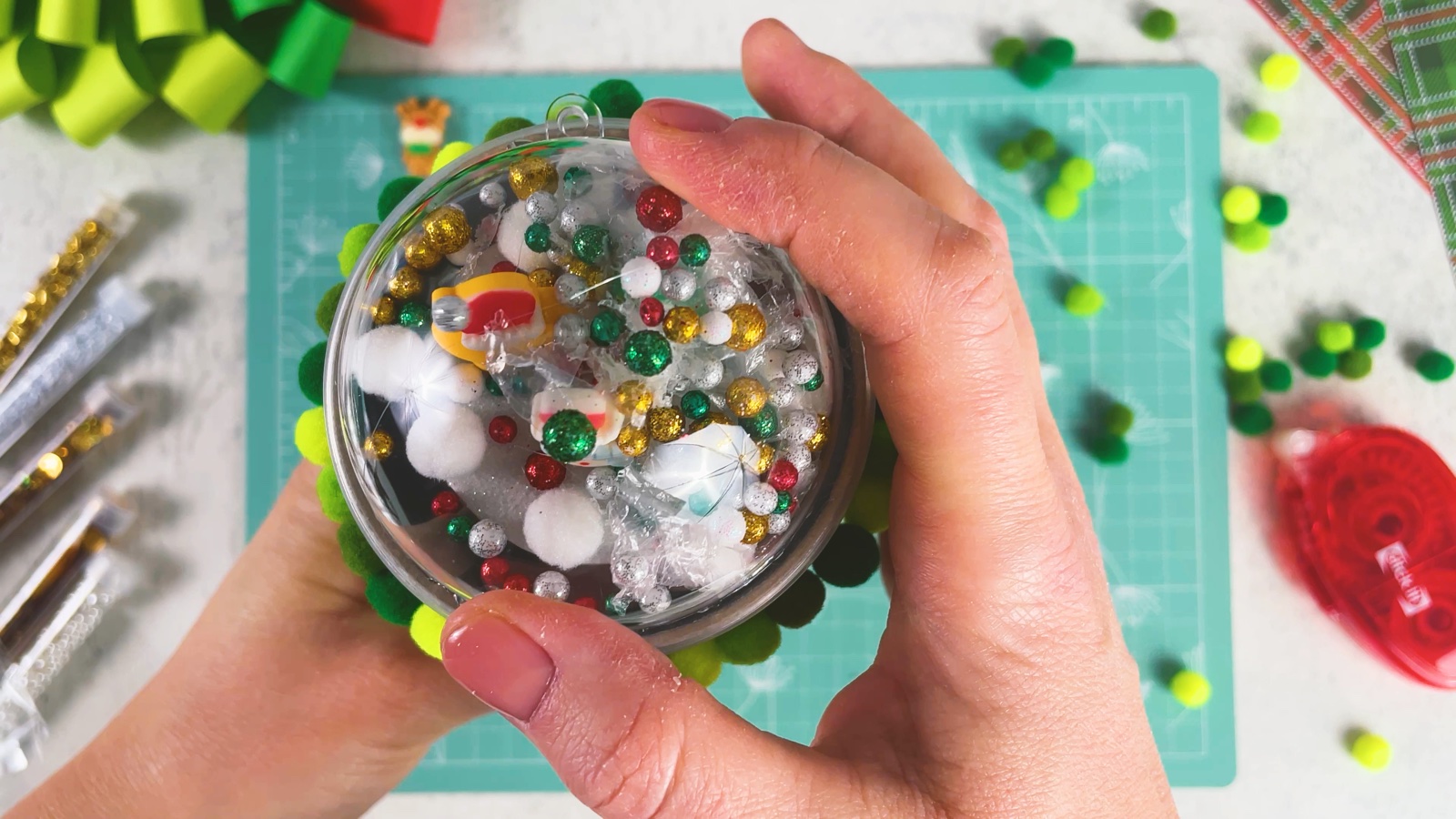 The dome glued onto the lid, full of beads, snow, snowballs and figurines