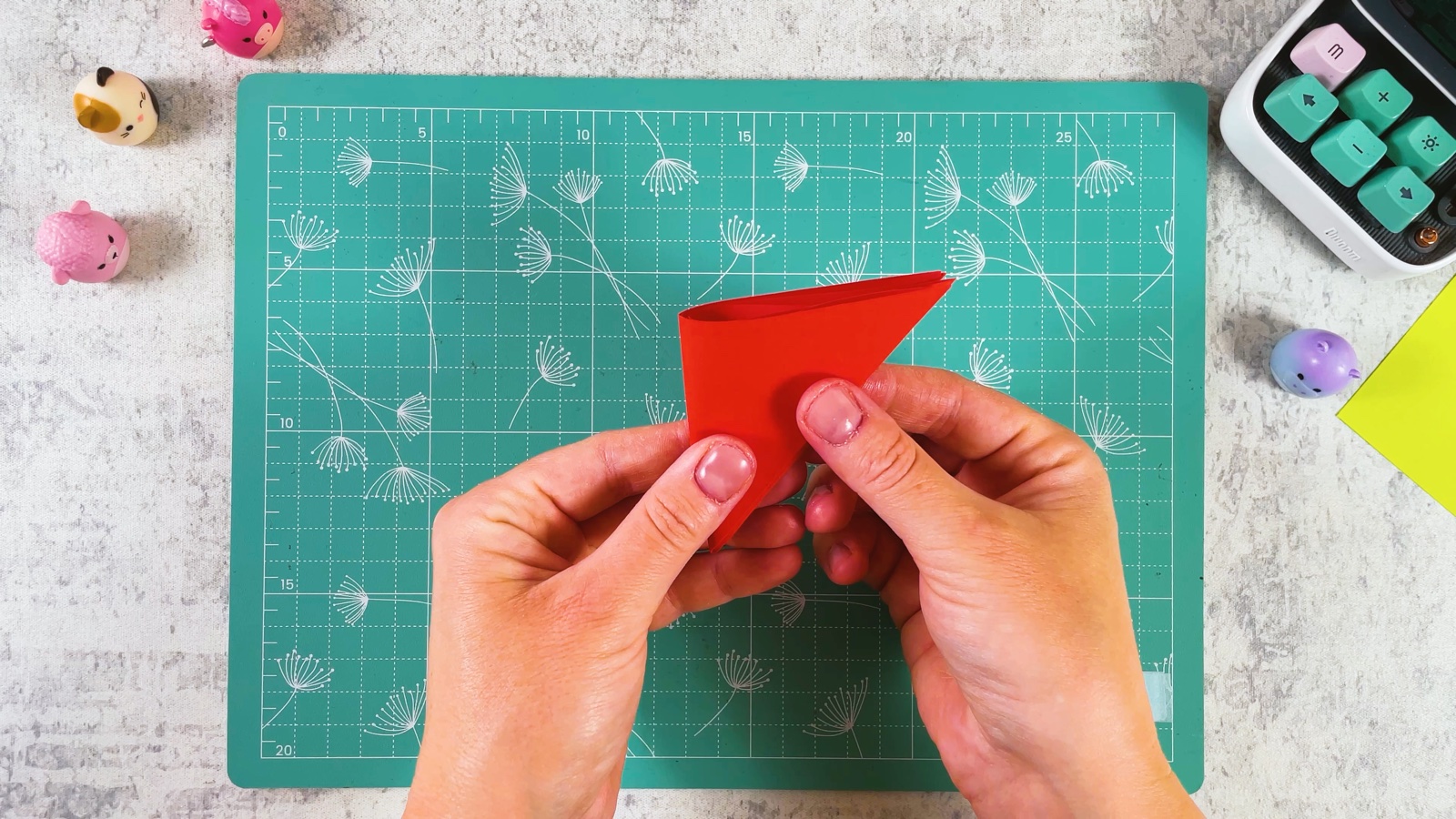 Folding the red triangle in half into a narrow wedge