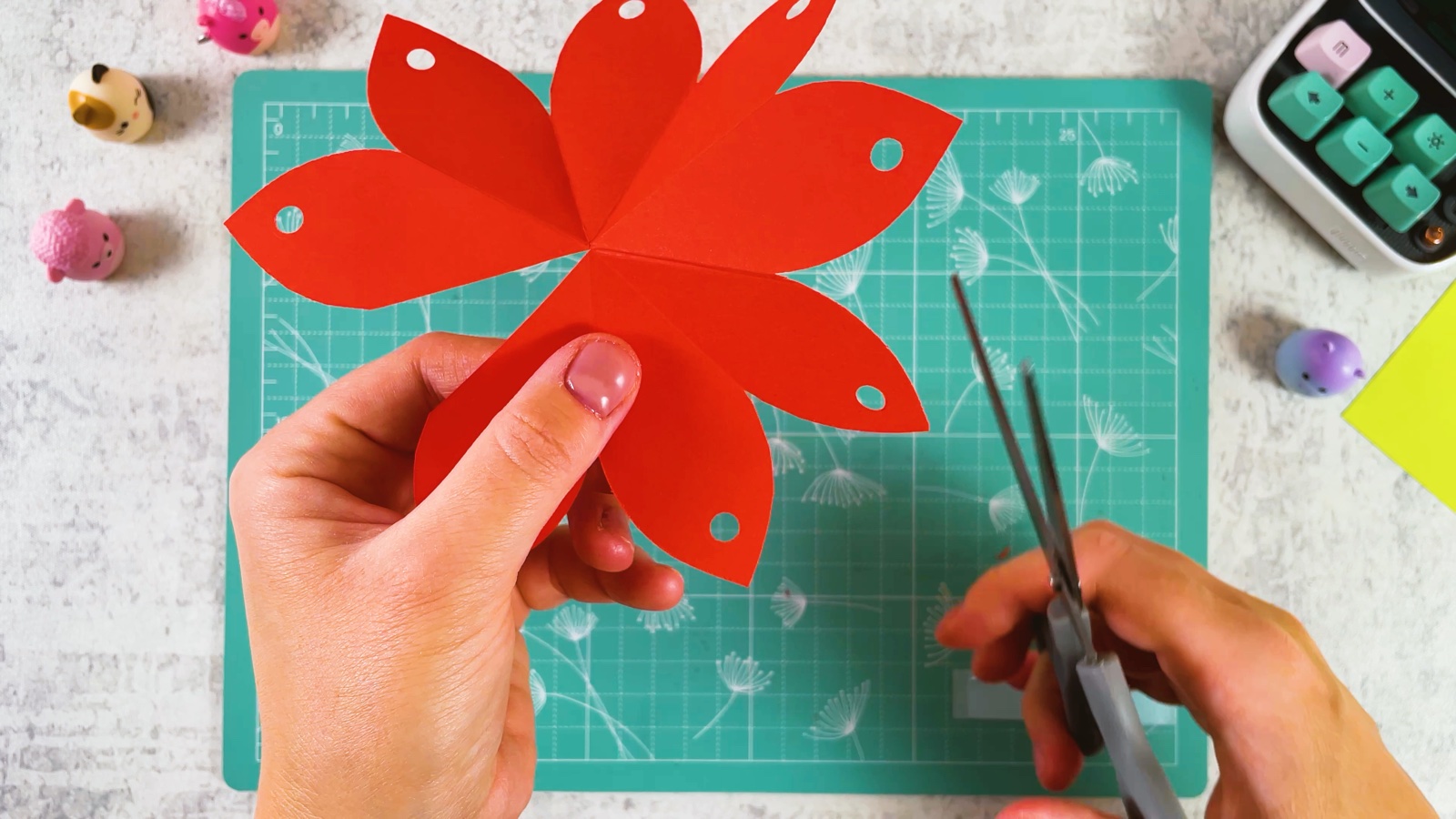 Cutting from the edge of the red flower to its centre along a fold line