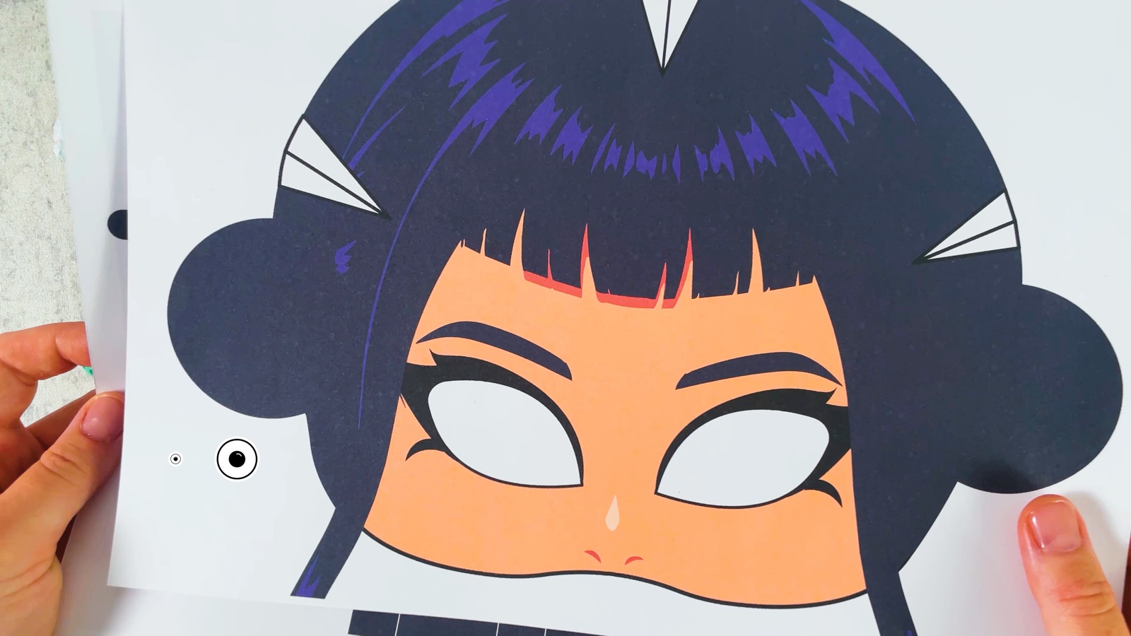 The printed template: Zoey’s face with dark hair, two round buns on the sides and three white triangles in the hair