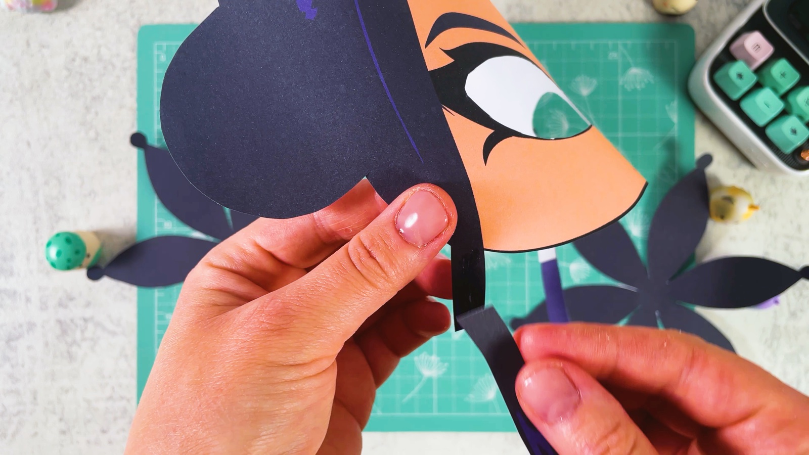 Pressing a thin dark strand to the back of the hair at the side of the mask