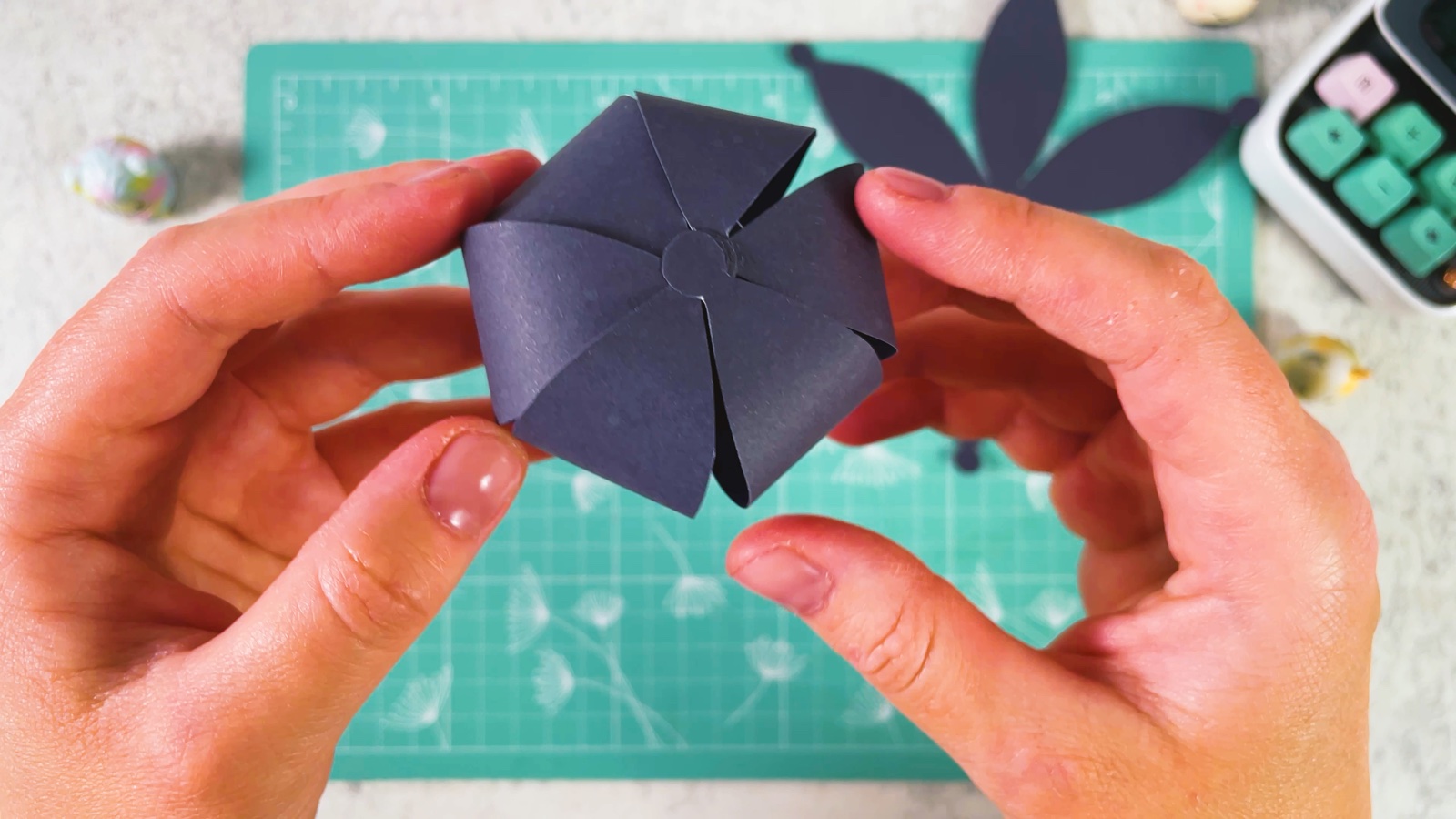 A finished round paper bun, seen from the top, with all the petal tips meeting in the middle