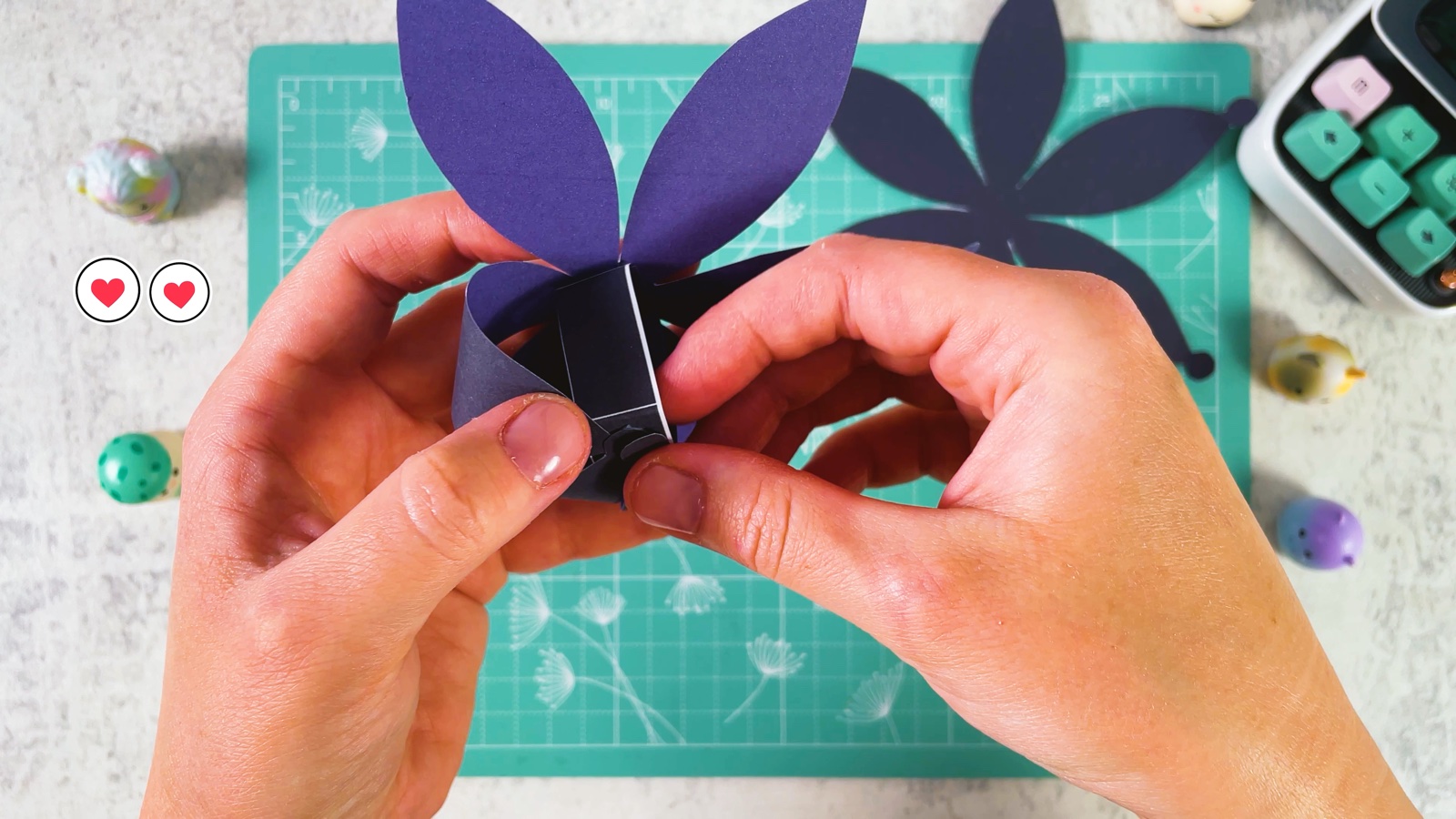 Bending a petal up over the little box to start the round bun