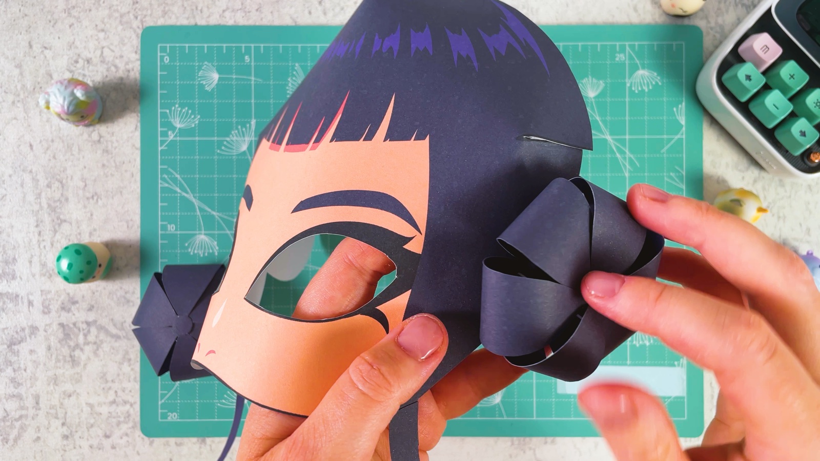 Pressing the paper bun onto the round printed bun at the side of the mask