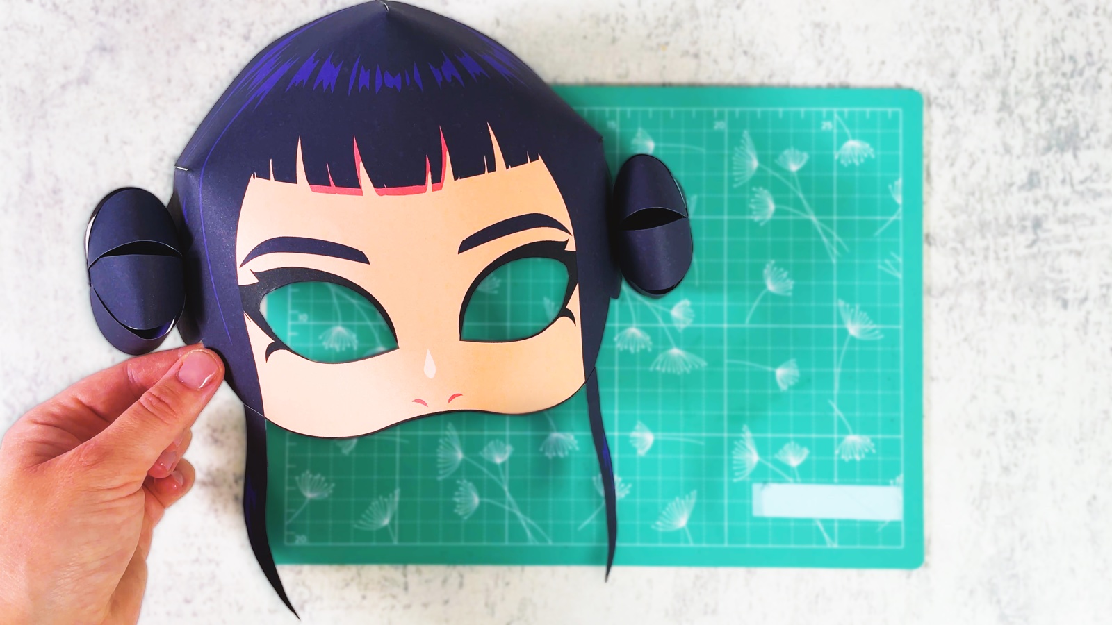 Finished paper Zoey mask with dark hair and two round buns