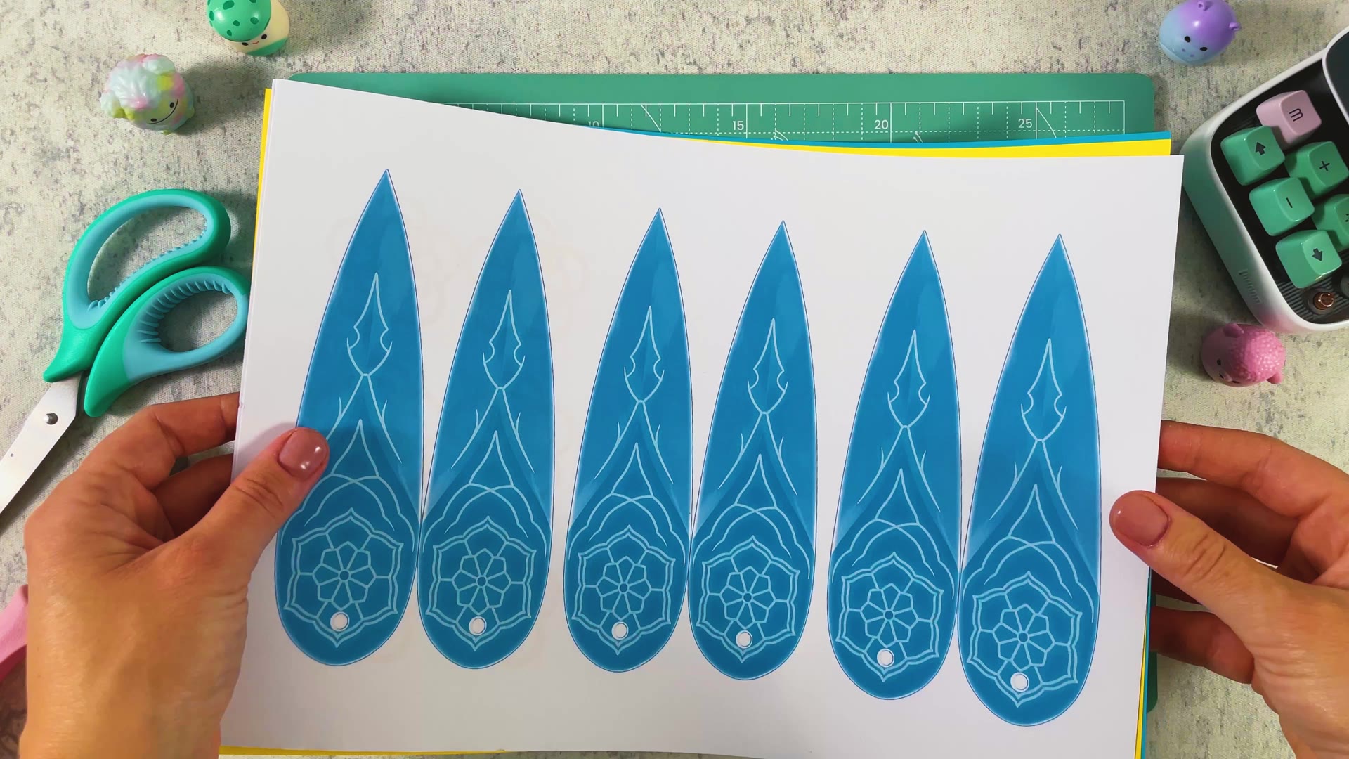 The printed blade template on white paper, with yellow paper and scissors on the cutting mat