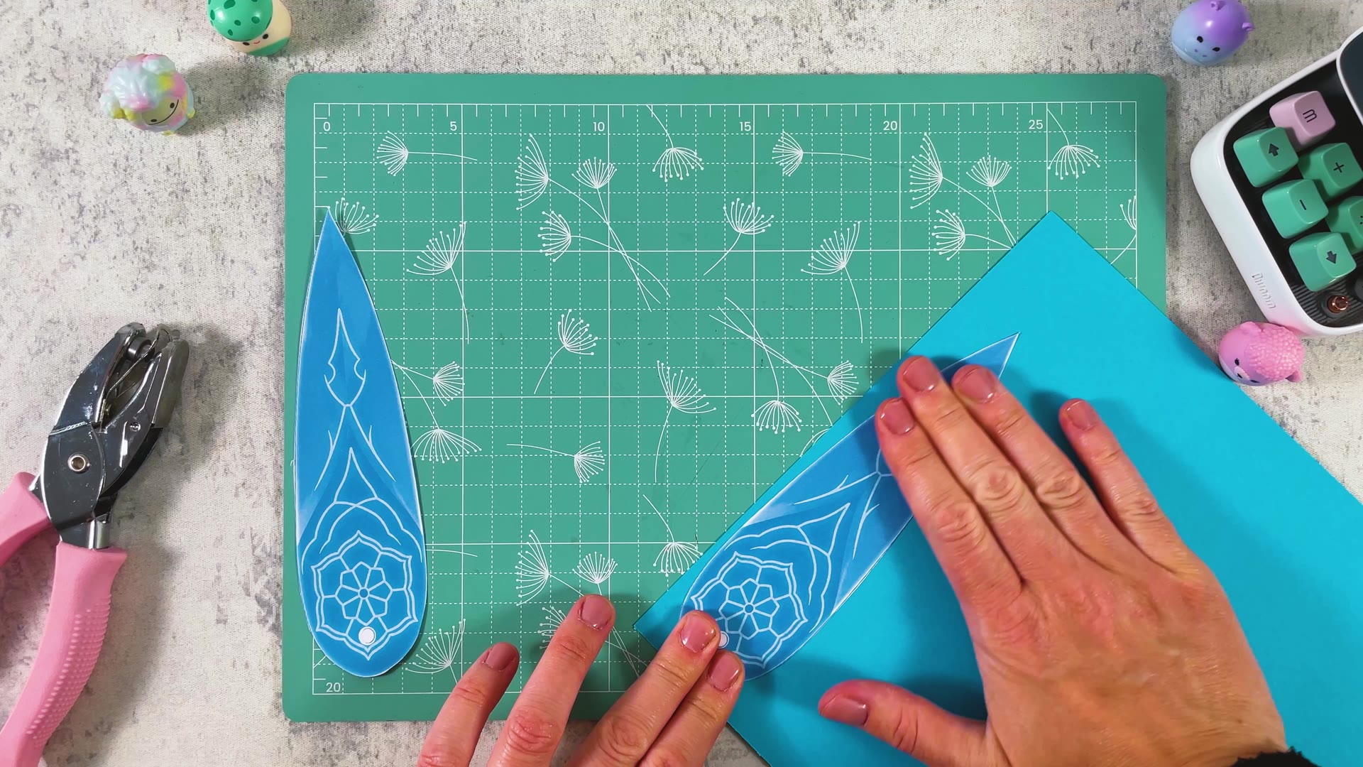 Pressing a printed blade onto a sheet of blue paper
