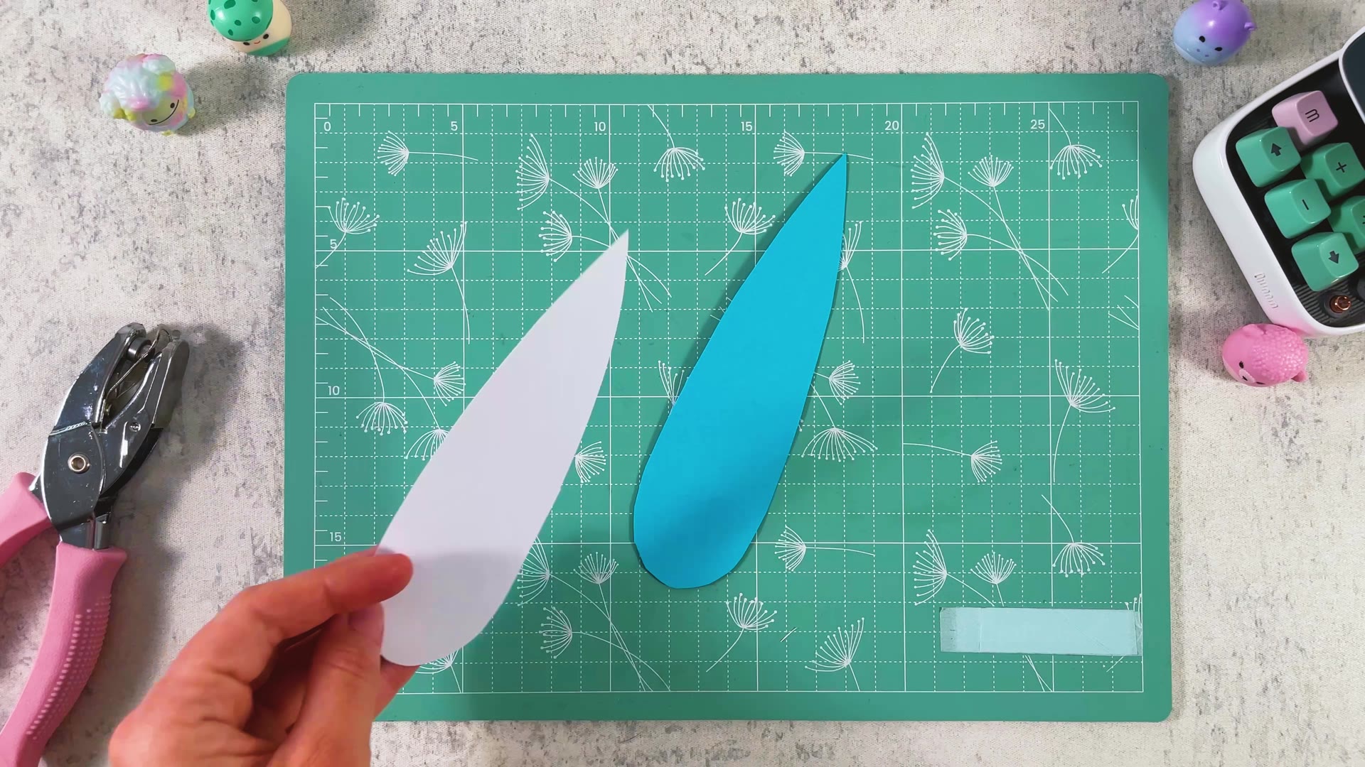 A second printed blade, shown from the white back, next to the plain blue side of the first blade