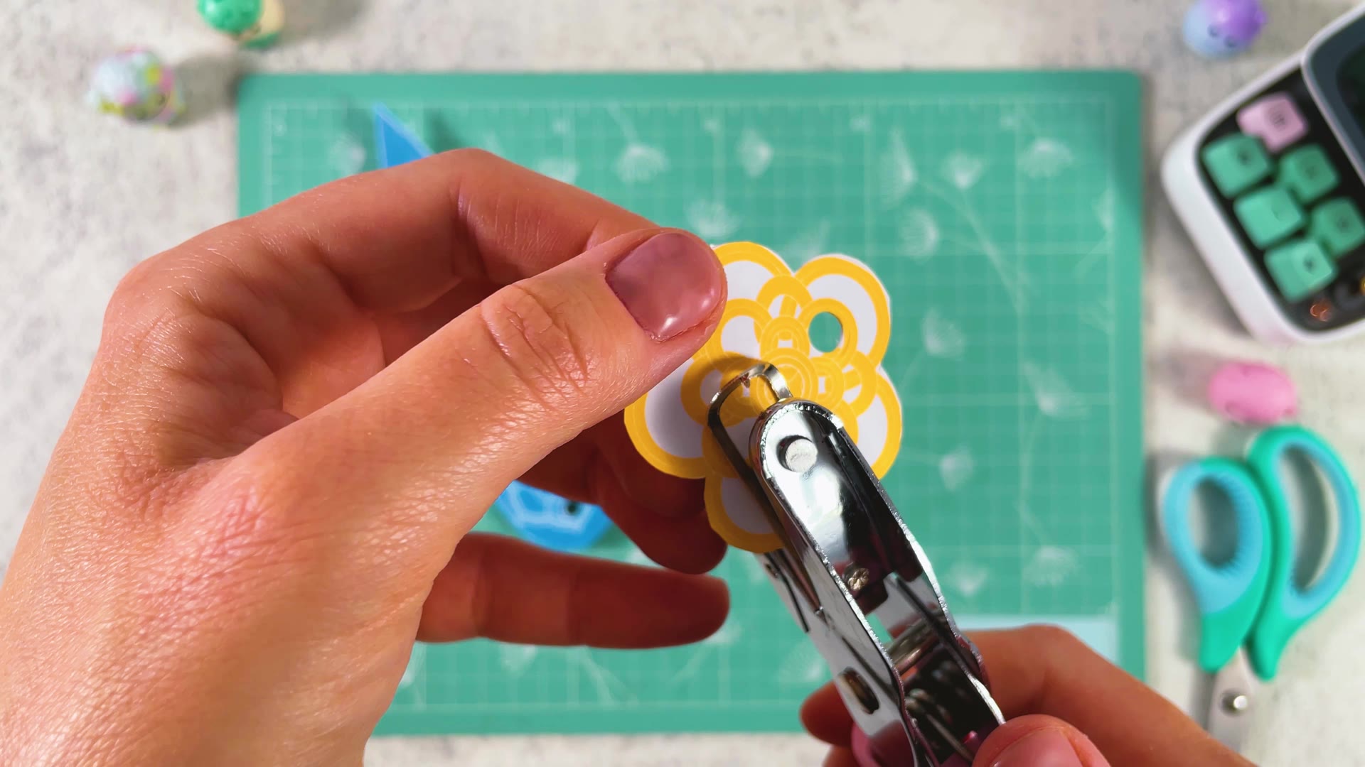Punching holes in the flower charm