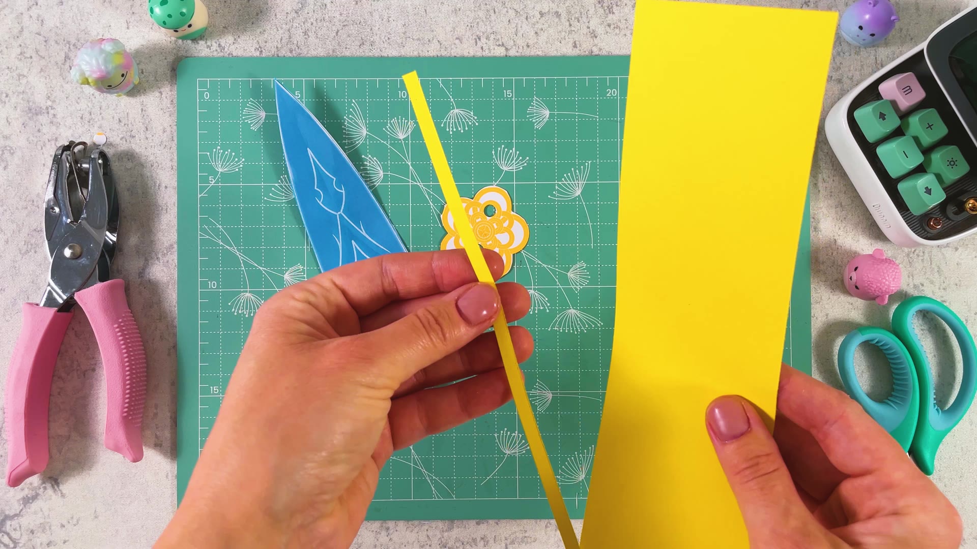 Cutting a thin strip from yellow paper