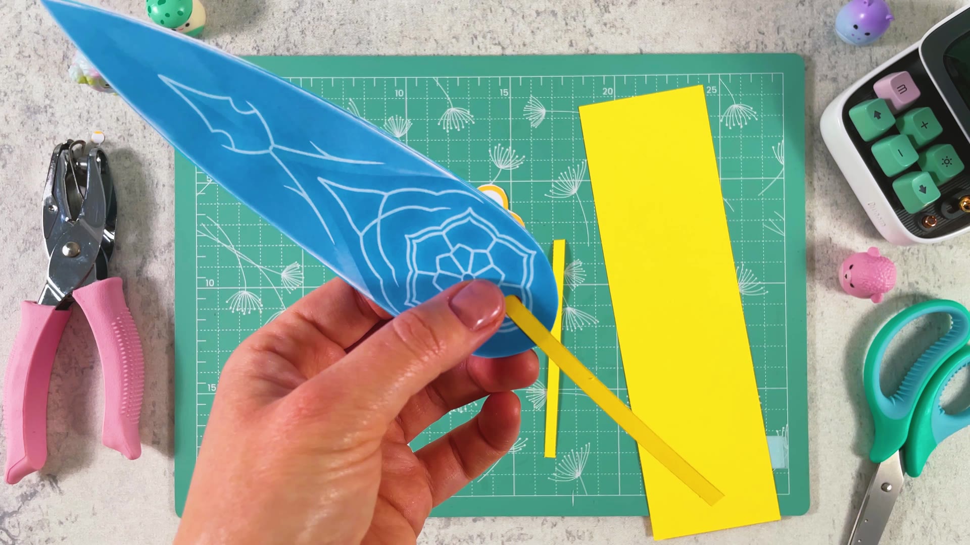 Threading a yellow strip through the hole in the blade