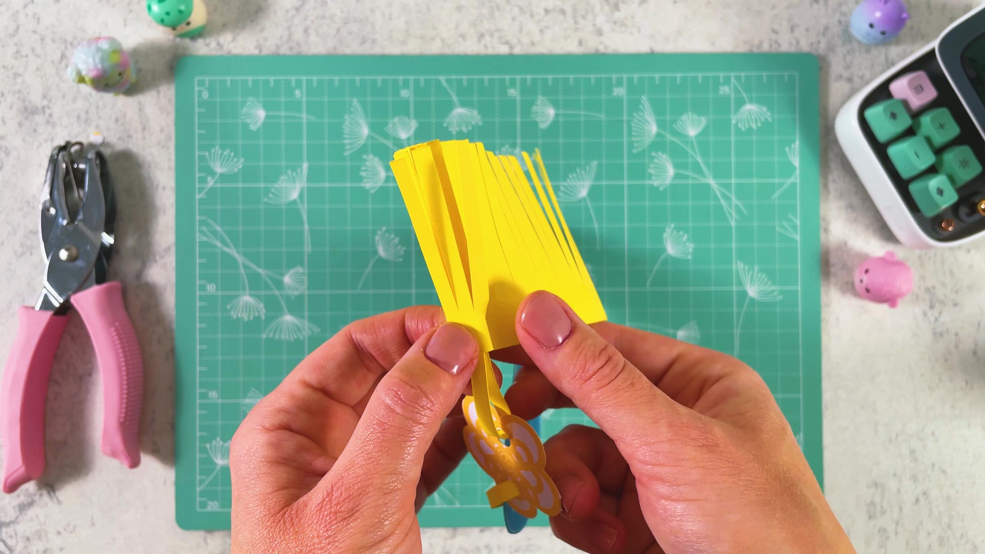 Holding the rolled tassel until the glue sets